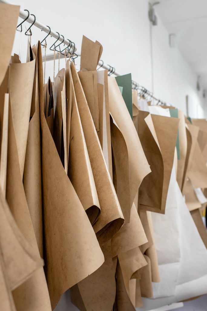 Set of sewing patterns on hangers inside tailor atelier or studio